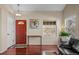 Bright entryway with hardwood floors, a vibrant red door and natural light at 1271 Berganot Trl, Castle Pines, CO 80108