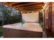 Inviting hot tub with sparkling water surrounded by lush greenery and ambient lighting at 1271 Berganot Trl, Castle Pines, CO 80108
