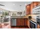 Bright and airy kitchen overlooking the living area, featuring stainless steel appliances and granite countertops at 1271 Berganot Trl, Castle Pines, CO 80108