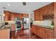 Modern kitchen featuring stainless steel appliances, granite countertops, and ample cabinet space at 1271 Berganot Trl, Castle Pines, CO 80108