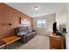 Cozy living room with a leather recliner and natural light at 1271 Berganot Trl, Castle Pines, CO 80108
