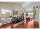 Open-concept living room with vaulted ceilings, hardwood floors, and ample natural light at 1271 Berganot Trl, Castle Pines, CO 80108