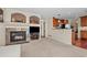 Open living space featuring a fireplace, built-in shelving, and seamless flow to the kitchen at 1271 Berganot Trl, Castle Pines, CO 80108