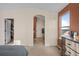 View from bedroom into en suite bathroom with a dresser, and a window at 1271 Berganot Trl, Castle Pines, CO 80108