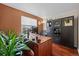 Cozy office with dark wood desk, built-in shelving and warm paint colors at 1271 Berganot Trl, Castle Pines, CO 80108