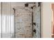 Tiled walk-in shower features dual showerheads and seamless glass enclosure at 1271 Berganot Trl, Castle Pines, CO 80108