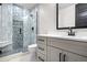 Modern bathroom with a walk-in shower, gray cabinets, and hexagon tile at 30410 E 161St Ave, Brighton, CO 80603