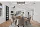 Open concept dining room with hardwood floors and modern lighting at 30410 E 161St Ave, Brighton, CO 80603