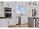 Modern kitchen with white cabinets, stainless steel appliances and hardwood floors at 30410 E 161St Ave, Brighton, CO 80603