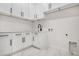 Clean laundry room with white cabinets at 30410 E 161St Ave, Brighton, CO 80603