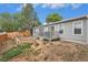 Backyard with a deck area, fenced yard, and garden beds ready for planting at 1390 W 78Th Cir, Denver, CO 80221