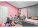 Bright bedroom with a crib and chair at 1390 W 78Th Cir, Denver, CO 80221