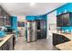 Open kitchen with granite countertops, stainless steel appliances, and breakfast bar at 1390 W 78Th Cir, Denver, CO 80221