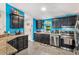Well-lit kitchen with granite countertops, black cabinets, and stainless steel appliances at 1390 W 78Th Cir, Denver, CO 80221