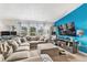 Spacious living room with plush sectional sofa, large windows, and a modern fireplace at 1390 W 78Th Cir, Denver, CO 80221