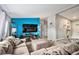 Comfortable living room features a large sectional couch, fireplace, and bright turquoise accent wall at 1390 W 78Th Cir, Denver, CO 80221
