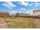 Expansive backyard featuring a well-maintained lawn, wooden fence, and play set at 7232 Shavano Ave, Frederick, CO 80504
