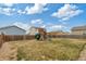 Backyard featuring a play structure, fenced yard, and ample space for outdoor activities at 7232 Shavano Ave, Frederick, CO 80504