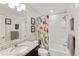 Bright bathroom featuring a shower, vanity, and bathtub. With bright dinosaur-themed decor at 7232 Shavano Ave, Frederick, CO 80504