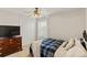 Cozy bedroom with a ceiling fan, dresser, and closet, creating a comfortable and inviting space at 7232 Shavano Ave, Frederick, CO 80504