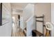Inviting entryway featuring wood-look flooring, coat rack, and views of the dining and kitchen areas at 7232 Shavano Ave, Frederick, CO 80504