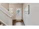 Inviting entryway featuring a textured-glass door, dark wood floors, and neutral walls at 7232 Shavano Ave, Frederick, CO 80504