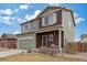 Charming two-story home featuring a porch swing, two-car garage, and a well-maintained lawn at 7232 Shavano Ave, Frederick, CO 80504