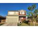 Two-story home with a two-car garage, two-tone paint, and a green lawn at 7232 Shavano Ave, Frederick, CO 80504
