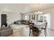 Open-concept living and dining area with modern furnishings and hardwood flooring at 7232 Shavano Ave, Frederick, CO 80504