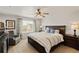 Spacious main bedroom boasts a ceiling fan and a cozy sitting area near the window, great natural light at 7232 Shavano Ave, Frederick, CO 80504