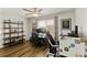 Stylish office space with wood floors, ceiling fan, and shelving for storage, perfect for remote work or study at 7232 Shavano Ave, Frederick, CO 80504
