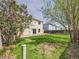 A lush backyard with a patio, bordered by greenery and a wooden fence at 5010 E 100Th Dr, Thornton, CO 80229
