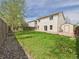 A spacious, grassy backyard featuring a shed and a wooden fence at 5010 E 100Th Dr, Thornton, CO 80229