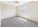 Sun-filled bedroom features carpet, ceiling fan, and natural light at 5010 E 100Th Dr, Thornton, CO 80229