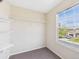 Bedroom closet with built-in shelving and a bright window at 5010 E 100Th Dr, Thornton, CO 80229