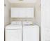 Bright laundry room features a washer, dryer, and ample storage space at 5010 E 100Th Dr, Thornton, CO 80229