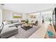 Bright living room features a comfortable sectional, stylish rug, and modern decor at 5010 E 100Th Dr, Thornton, CO 80229