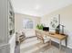 Bright office with a modern desk, large window, decorative rug, and a built-in bookcase at 5010 E 100Th Dr, Thornton, CO 80229