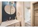 Stylish bathroom featuring a modern vanity, round mirror, and elegant fixtures at 10457 Owens Cir, Broomfield, CO 80021