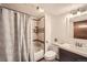 Clean bathroom with tiled shower and tub, decorative mirror, and modern fixtures at 10457 Owens Cir, Broomfield, CO 80021