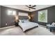 Comfortable bedroom with a ceiling fan, two windows, and a well-made bed and bedding at 10457 Owens Cir, Broomfield, CO 80021