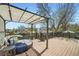 Relaxing outdoor deck space with covered seating, wooden floors, and dark wood railing for enjoying the outdoors at 10457 Owens Cir, Broomfield, CO 80021