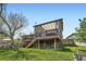 Back exterior view of the home with a wooden deck, canopy and well-maintained lawn in a suburban setting at 10457 Owens Cir, Broomfield, CO 80021