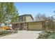Charming two-story home featuring a brick-accented facade, a spacious front yard, and an attached two car garage at 10457 Owens Cir, Broomfield, CO 80021