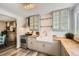 Stylish kitchen featuring a stainless-steel range, farmhouse sink, wood countertops, and glass-front cabinets at 10457 Owens Cir, Broomfield, CO 80021