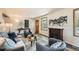 Cozy living room featuring stylish decor, a fireplace, and ample natural light at 10457 Owens Cir, Broomfield, CO 80021