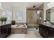 A luxurious bathroom with a separate soaking tub, walk-in shower, and dual vanities at 8464 E 55Th Pl, Denver, CO 80238