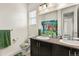 Charming bathroom featuring a double vanity, bright lighting, and a colorful Scooby Doo shower curtain at 8464 E 55Th Pl, Denver, CO 80238