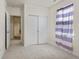 Bedroom featuring neutral carpet and a closet, offering a simple and functional space at 8464 E 55Th Pl, Denver, CO 80238