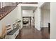 Grand entryway featuring dark wood floors, a staircase, and an open view into the living room at 8464 E 55Th Pl, Denver, CO 80238